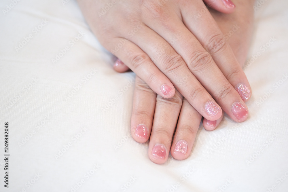 Hands placed on a white pillow Hands placed on a white pillow