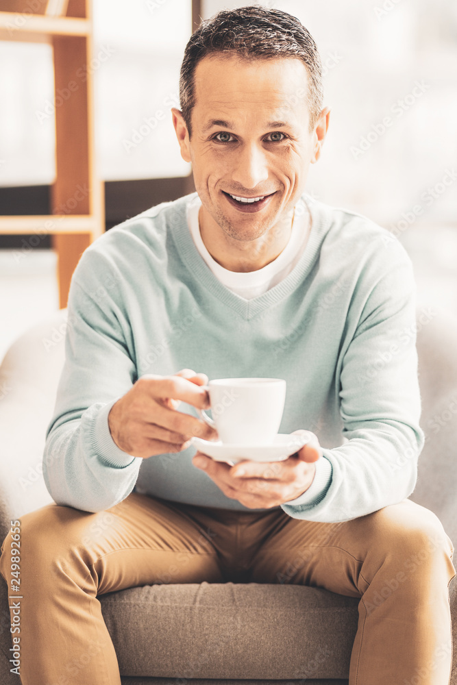 Handsome man feeling happy spending weekend at home Handsome man feeling happy spending weekend at home