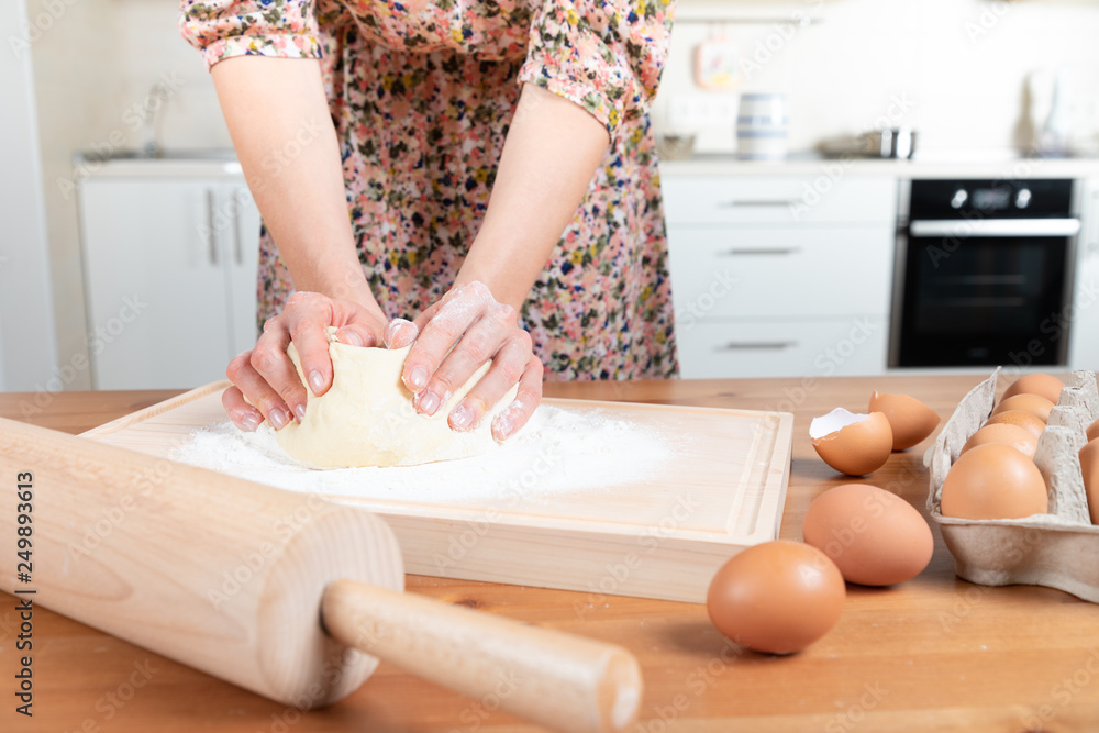 Young beautiful girl making dough Young beautiful girl making dough