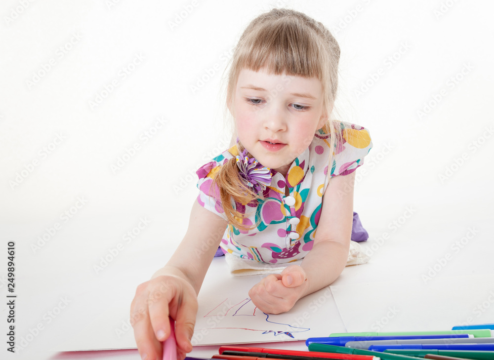 Smiling little girl thinking about her drawing Smiling little girl thinking about her drawing