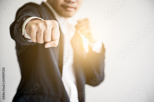 Business Fighting to success Concept. Businessman with fighting pose with lens flare effect. © SP56