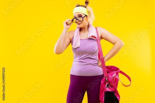 Young woman wearing glasses feeling excited before gym