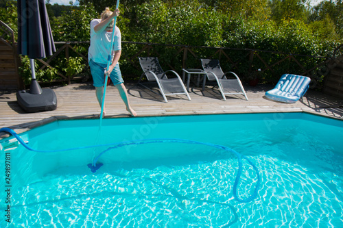 woman cleaning swimming pool