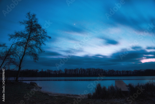 Long exposure on a lake with jetty during the blue hour. Concept: postcards, calendars or recreation and travel © andre