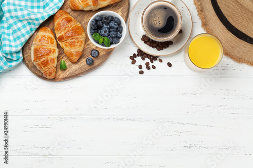 Coffee, juice and croissants breakfast