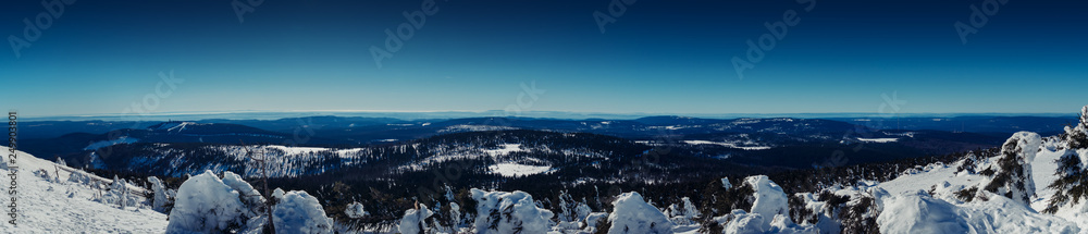 Winter mountain landscape panorama from the mountain top to the valley in winter with snow. Brocken Plateau, National Park Harz Mountains in Germany