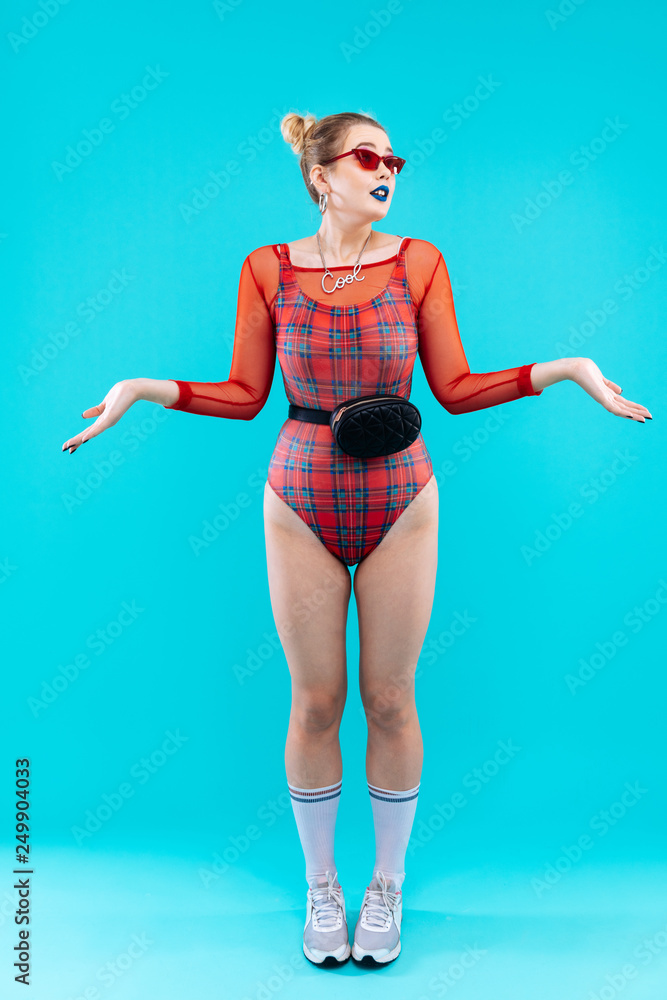 Fashionable slim model wearing red bodysuit and stylish necklace Fashionable slim model wearing red bodysuit and stylish necklace