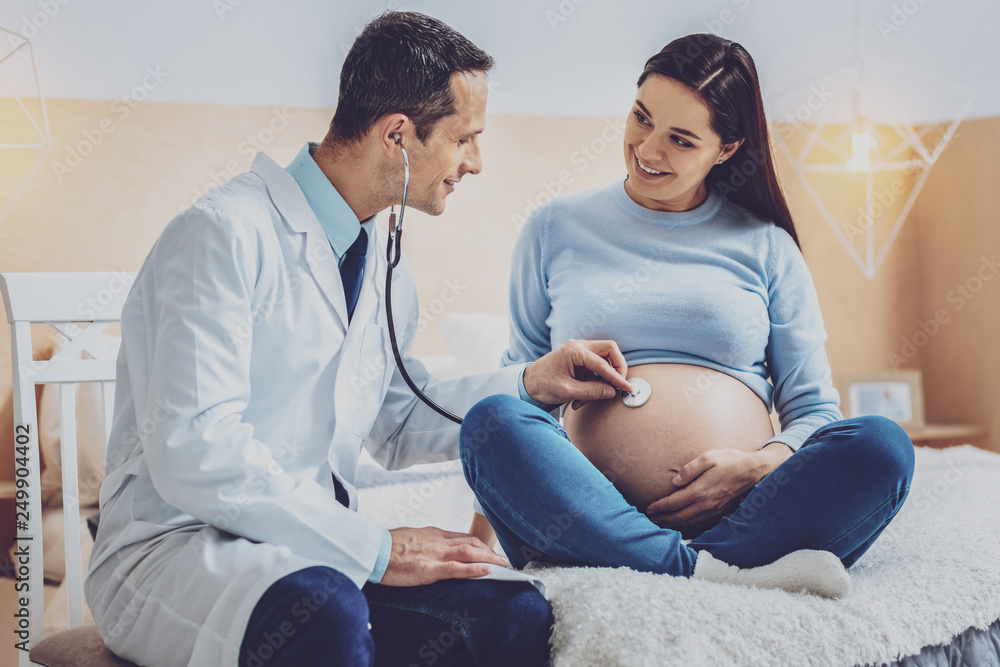 Attentive medical worker examining pregnancy Attentive medical worker examining pregnancy
