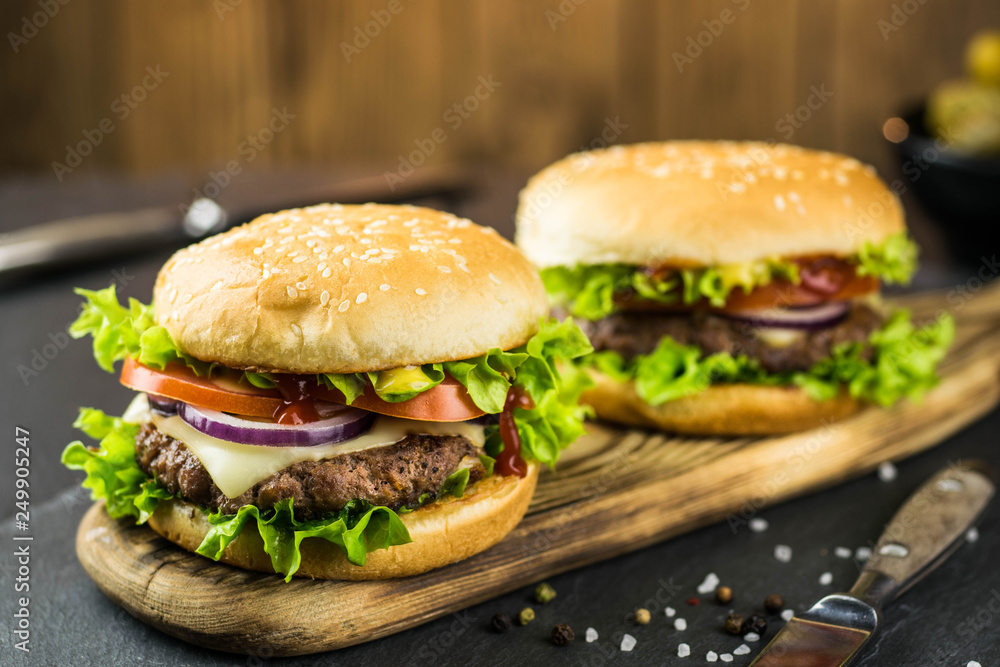 Delicious hamburgers on wooden background 