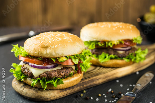 Delicious hamburgers on wooden background 