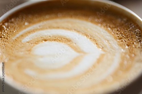  Cappuccino milk foam with bubbles in a white cup, shot on a macro lens