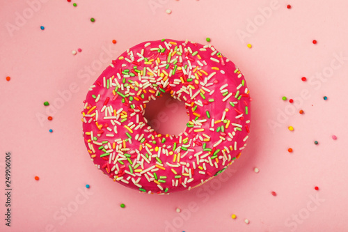 Strawberry donut on a pink background, top view