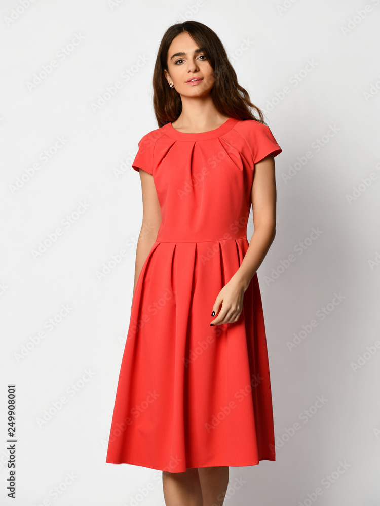 Young beautiful woman posing in new fashion casual red winter dress on white 