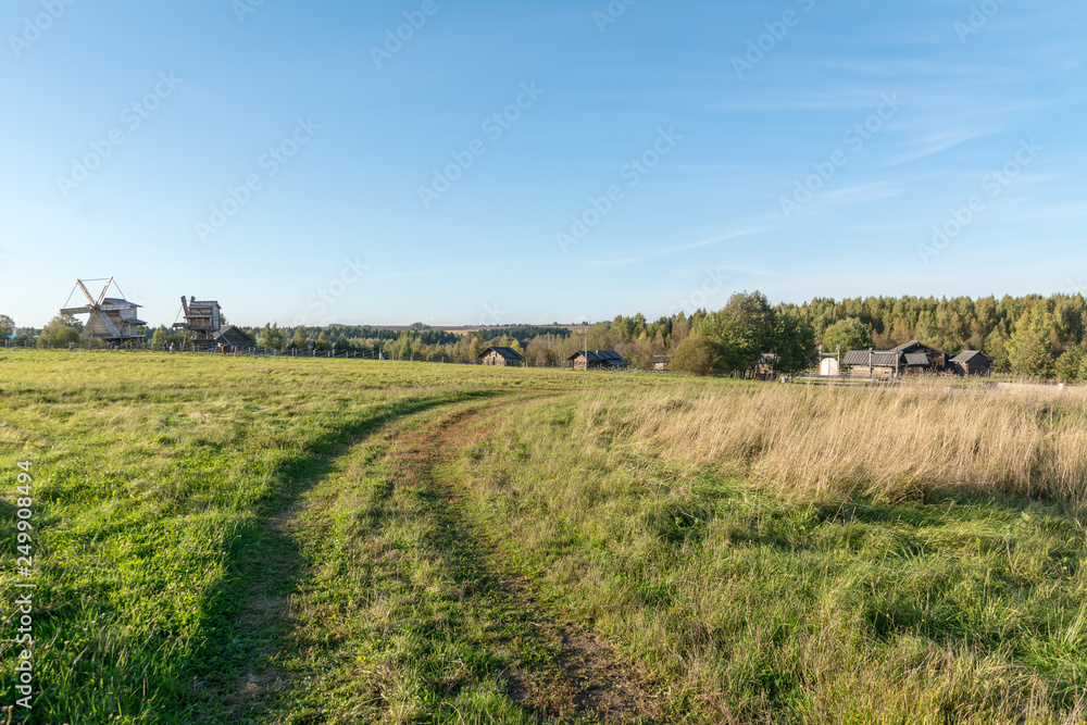 The road through the meadow to the village