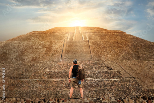 Sporty young tourist on the background of a Teotihuacan sunset. Pyramid of the Sun. Travel and freedom concept. photo