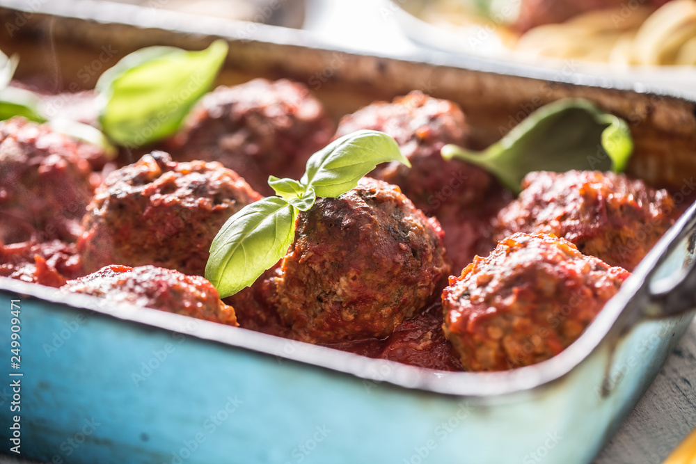 Delisious italian meal meat beef balls with basil in vintage roaster pan.