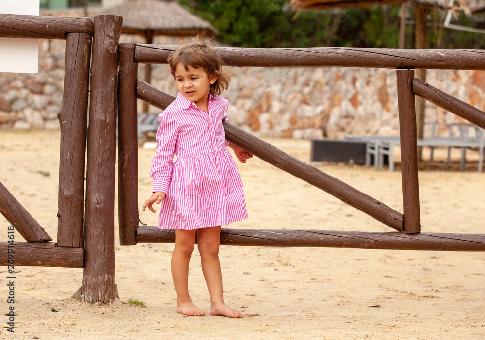 Happy little girl relaxing by the beach Happy little girl relaxing by the beach