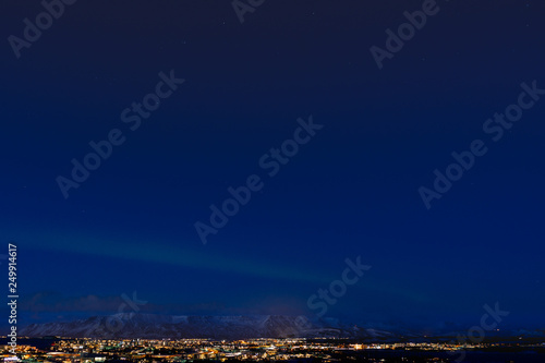 Northern lights in Reykjavik, Iceland, shining over mount Esja © KatalysatorAV