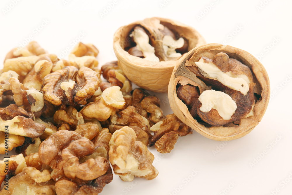 A pile of peeled walnuts at white background	