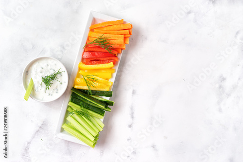 Colorful vegetable sticks with yogurt dip. Top view.