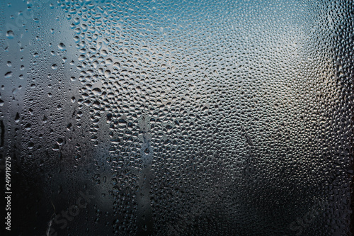 sweaty glass with frozen drops beautiful blue bokeh