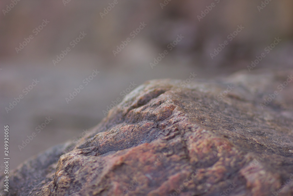 Granite rocks with blurred background. Granite close up. Texture of the stone. Natural material background Granite rocks with blurred background. Granite close up. Texture of the stone. Natural material background