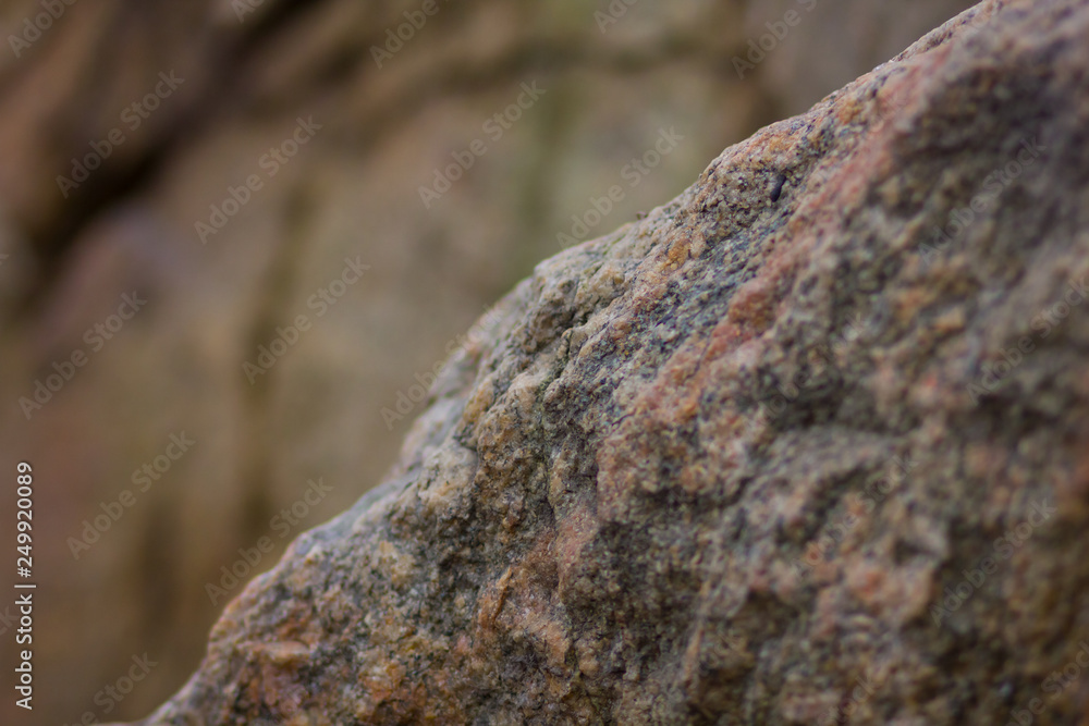 Granite rocks with blurred background. Granite close up. Texture of the stone. Natural material background Granite rocks with blurred background. Granite close up. Texture of the stone. Natural material background