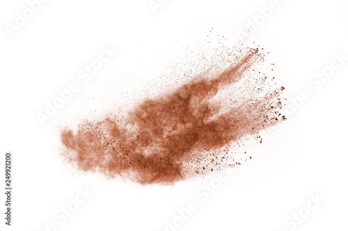 Brown color powder explosion on white background. Colored cloud. Colorful dust explode. Paint Holi.