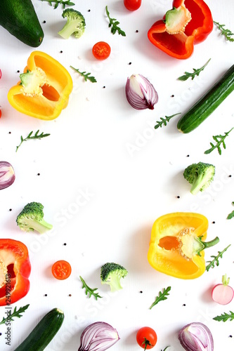 Various vegetables and herbs on white background. Top view with copy space. Vegetarian and vegan food.