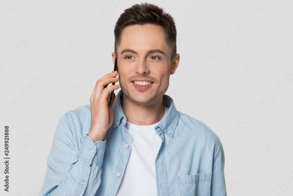 Happy man holding cellphone talking on phone isolated on background Happy man holding cellphone talking on phone isolated on background