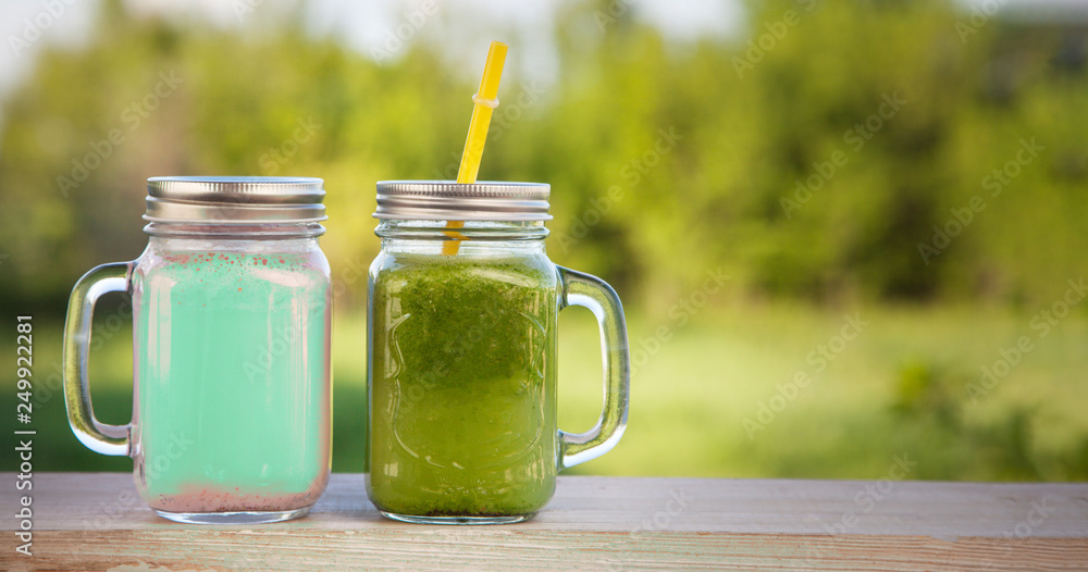 glass of detox smoothie on wooden table in the summer garden with fruit glass of detox smoothie on wooden table in the summer garden with fruit