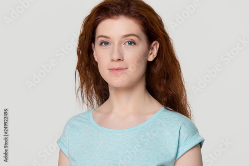 Headshot of young woman with beautiful face and red hair