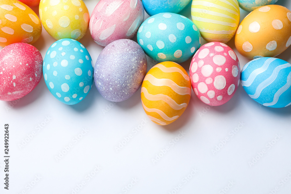 Obraz premium Decorative Easter eggs on white background, space for text. Top view