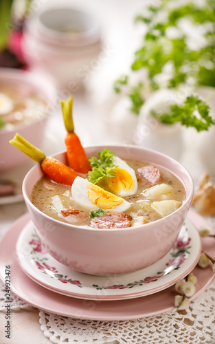 Bowl of the the sour soup (Żurek), polish Easter soup with the addition of sausage, hard boiled egg and vegetables . Traditional Easter dish in Poland