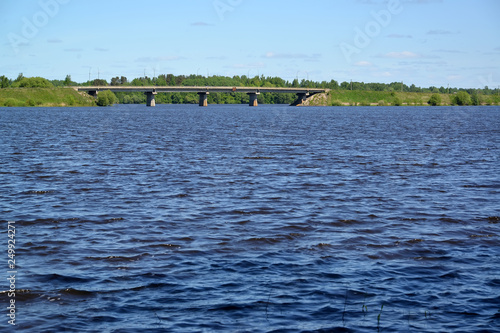 The river Sogozha with the automobile bridge on a distance shot. Poshekhonje, Yaroslavl region photo