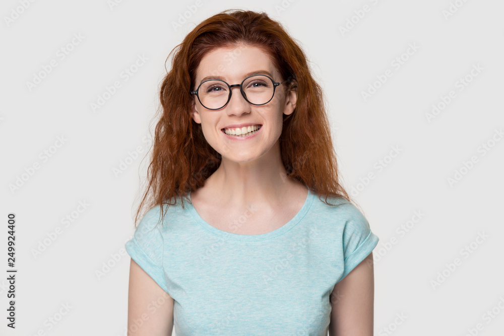 Head shot portrait of cute redhead girl in glasses