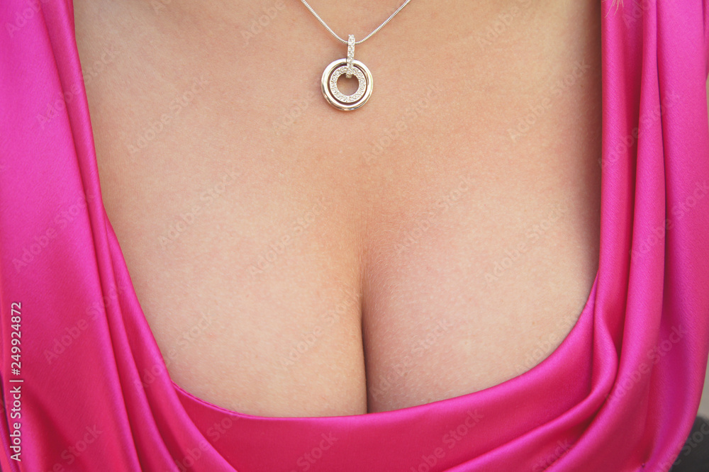 Female sensual cleavage with a pendant hanging on the neck. Copy