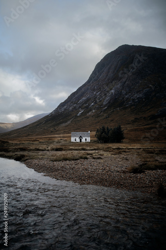View of house by lake with mountain in background