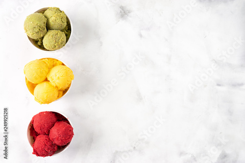 Fruit colorful sorbet on white background seeng from above photo