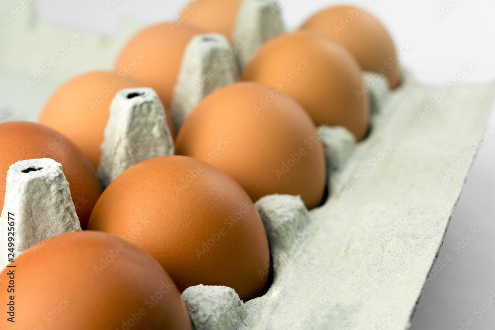 raw chicken eggs in egg box. white background raw chicken eggs in egg box. white background