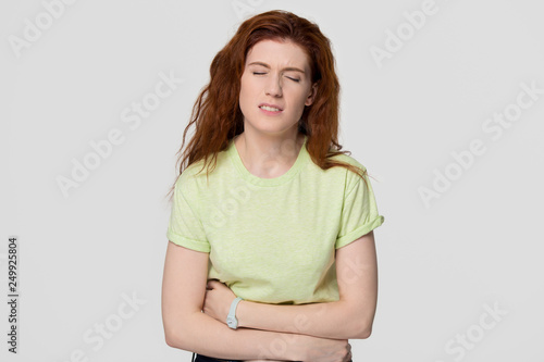 Canvastavla Sick upset redhead woman feeling stomach ache holding belly