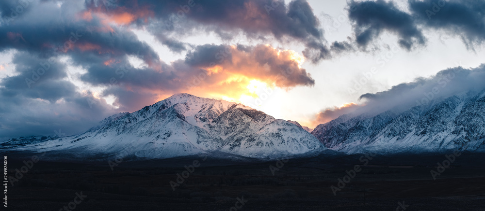 SUneset behing snowy california sierra mountains