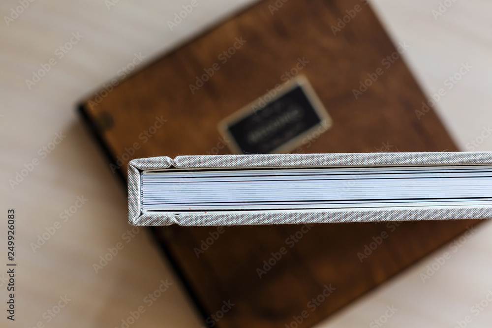 Photo book with a cover of genuine leather. White color with openwork stamping. Soft focus. Photo book with a cover of genuine leather. White color with openwork stamping. Soft focus.