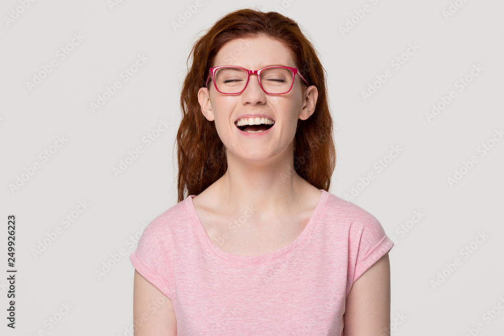 Happy funny redhead girl laughing out loud at humorous joke Happy funny redhead girl laughing out loud at humorous joke