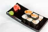 Sushi and rolls on black plate. Sea healthy japanese asian food