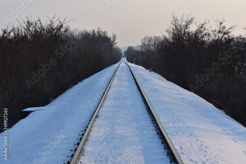 Railroad in the winter, the train is coming