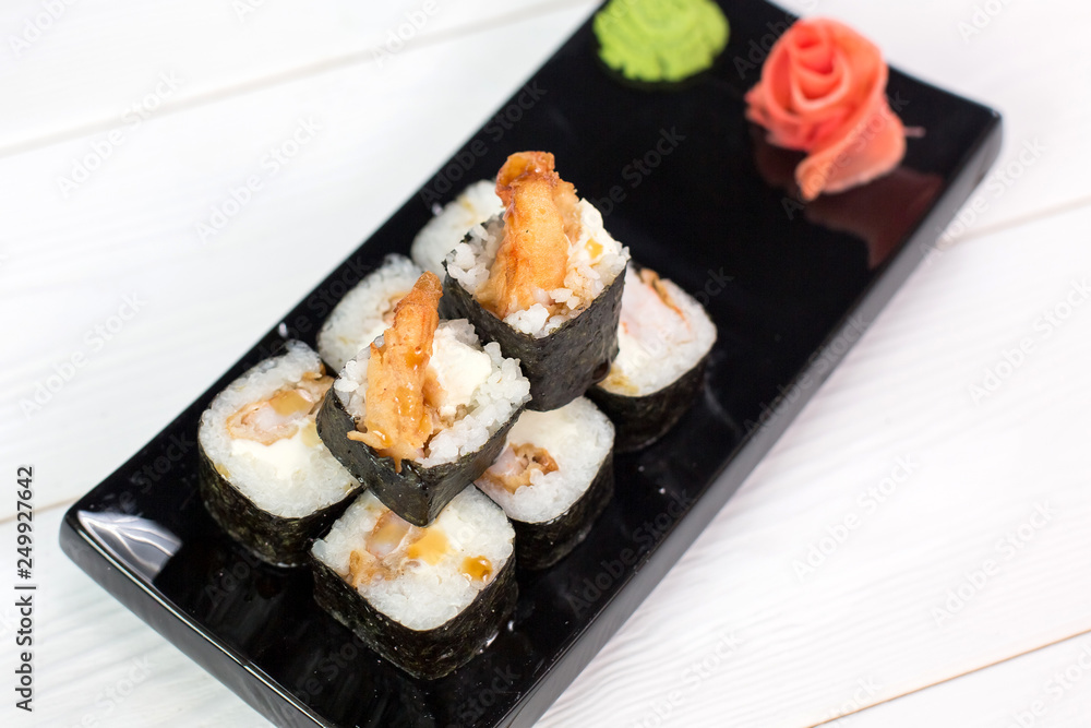 Sushi and rolls on black plate. Sea healthy japanese asian food Sushi and rolls on black plate. Sea healthy japanese asian food