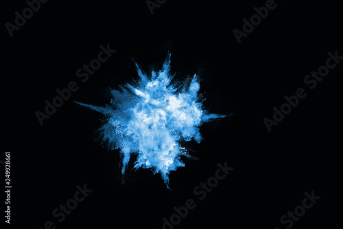 Blue powder explosion on black background. Colored cloud. Colorful dust explode. Paint Holi.