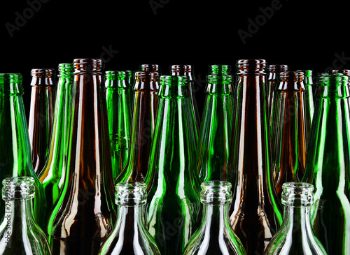 Empty clean glass bottles on a black background.