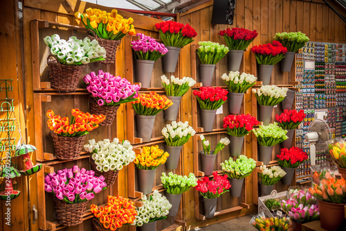 Photography Colorful tulips bouquets arrangements at the wall in plastic cans at flower mark